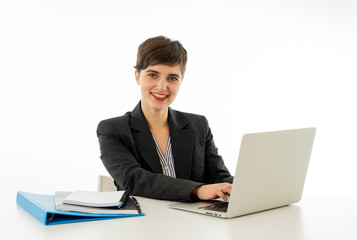 Portrait of happy attractive young businesswoman working on her laptop looking confident