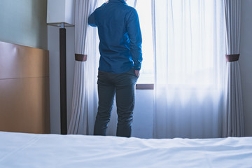 窓の側に立つ男性