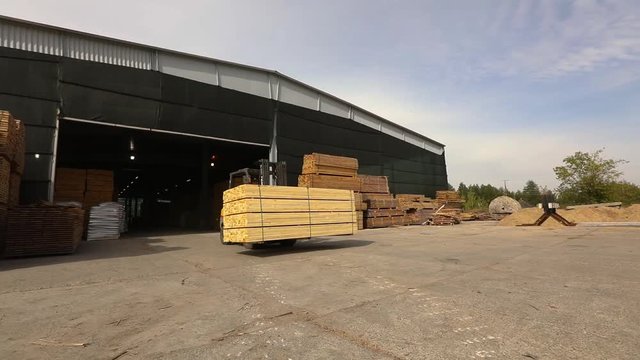 Forklift rides around the factory, the forklift transports boards