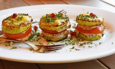 Vegetarian appetizer of fried vegetables with sauce close-up vertically.