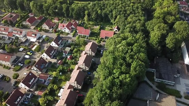 Drone view of an area of Dronten, Flevoland, The Netherlands. Tilting to reveal wooded area.