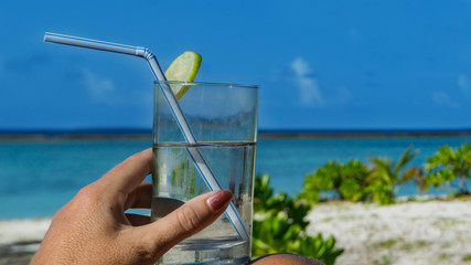 Cold drink on the beach with lemon
