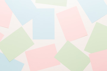 Abstract geometric background in light pastel tones from sheets of thick pale past paper.