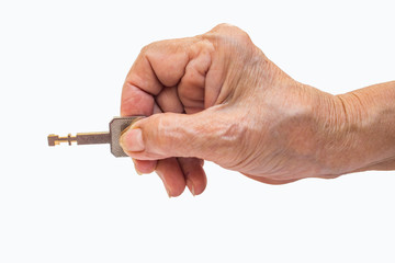 Senior woman's right hand holding key isolated on white background