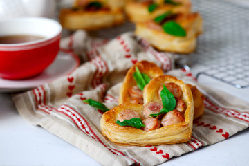 Puffs with sausages in heart shapes. Valentine's Day Breakfast