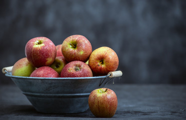 delicious red apples in old metal washtub