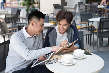 Vietnamese business partners chatting during the coffee break - Image