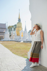 Traveller girl enjoying and looking at Buddhist stupas,Wat Suan Dok,Chiangmai,Thailand