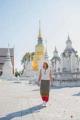 Traveller girl walking in the temple,Wat Suan Dok,Chaing Mai,Thailand.