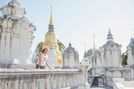 Traveller girl enjoying and looking at Buddhist stupas,Wat Suan Dok,Chiangmai,Thailand
