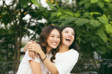 young pretty girlfriends over nature background, in the garden