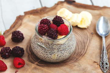 Healthy vanilla chia pudding in a glass with fresh berries