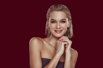 Famous TV host posing for her portrait near red wall