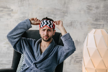 Happy man or bearded macho with beard smiling in open blue robe on sexy naked torso, belly, chest. Home and leisure clothing. Resting and relaxing - Image. Good morning.