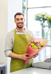 small business, sale and floristry concept - happy smiling florist with bunch at flower shop