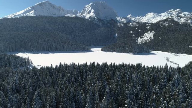 Aerial winter view of snow covered Black lake in Durmitor mountains national park