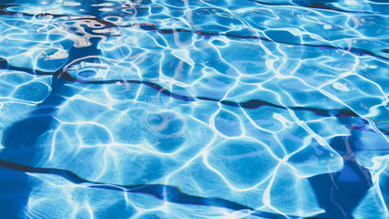 Ripple Water in swimming pool with sun reflection. Summer day at swimming pool. Background and texture concept