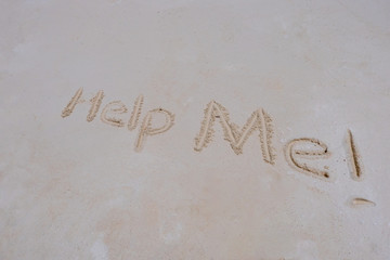 Help Me written in a sandy tropical beach
