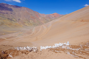 Fototapeta na wymiar Ice or snow penitentes and andean landscape at Paso De Agua Negra mountain pass, Chile and Argentina, South America