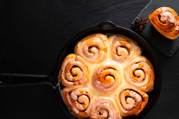 Food concept fresh baked homemade Cinnamon rolls in skillet cast iron pan with copy space