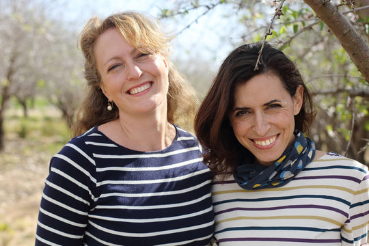 Portrait of two smiling real mature women outdoor
