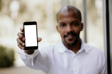 Young black African black entrepreneur holding hand cell phone with copy space screen for your advertising content before meeting with business partners