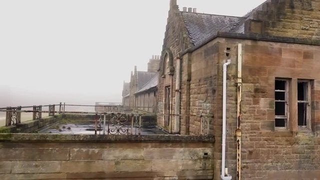 Aerial Shot Through the Fog of an Abandoned Asylum