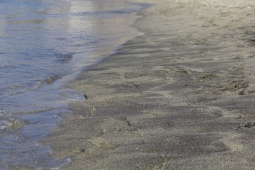 Waves on the black sand