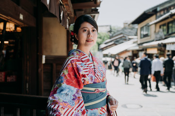 gorgeous japanese woman walking out from restaurant after having lunch in afternoon. young local...