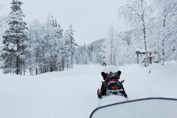 Snowmobile in a snowy lapland landscape, winter in finland. 