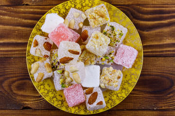 Turkish delight in a plate on wooden table