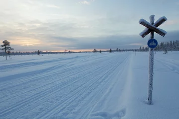 Frozen snowmobile track in a cloudy sunset, Lapland in Finland.  © Sofia