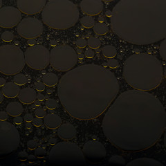 Abstract background of round oil bubbles on the water surface.