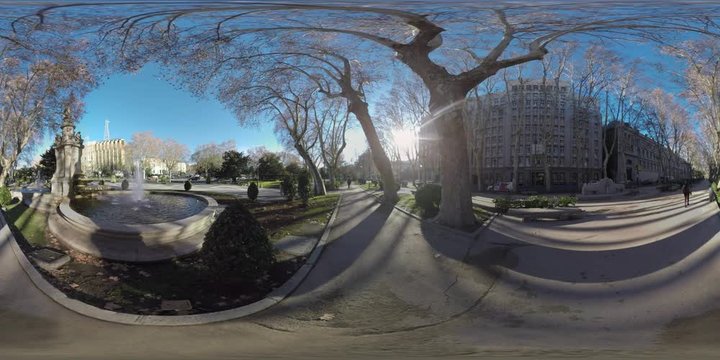 360 VR Paseo del Prado with Apollo Fountain in Madrid, Spain. View to the city buildings, car traffic and tree-lined pedestrian walkway