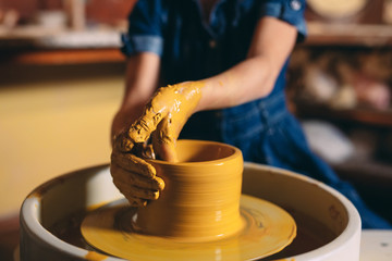 Pottery workshop. A little girl makes a vase of clay. Clay modeling