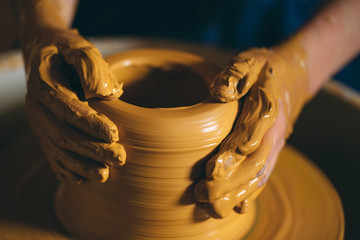Pottery workshop. A little girl makes a vase of clay. Clay modeling