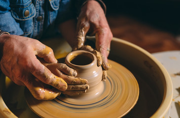 Pottery workshop. Grandpa teaches granddaughter pottery. Clay modeling