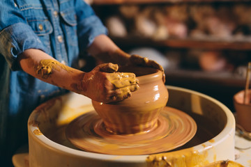 Pottery workshop. A little girl makes a vase of clay. Clay modeling