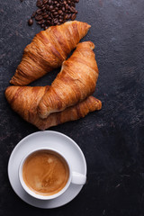 Top view of traditional croissants with hot coffee