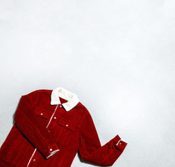 Red corduroy men's jacket on gray background top view flat lay copy space. Male fashion, winter...