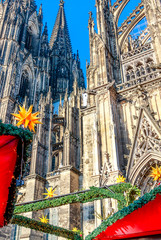 Naklejka premium Festive Christmas market in Cologne takes place in a fantastic location in front of the Cologne Cathedral, Germany