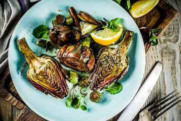 Cooked baked artichoke, alla romana, grilled artichoke flowers with olive oil, lemon, garlic, mint ...