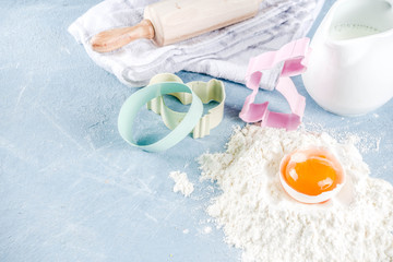 Easter baking culinary background with ingredients and props, on a light blue concrete background top view copy space
