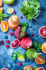 Smoothies in bottles with berries, spinach and fruits, healthy detox vitamin drink