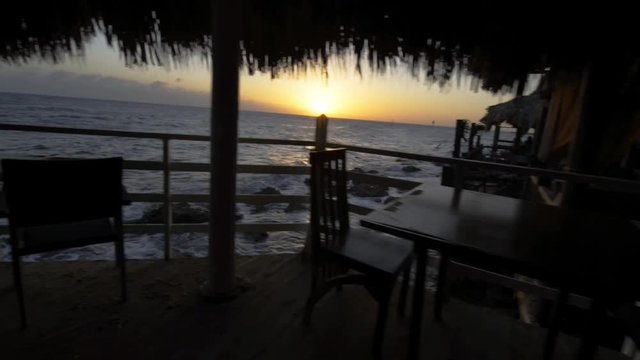 Steadycamshot in a cafee at sunset on the caribbean iseland Curacao.