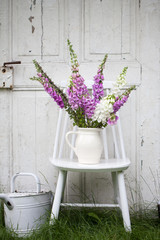 beautiful bouquet of field flowers - foxglove against the background of old white door