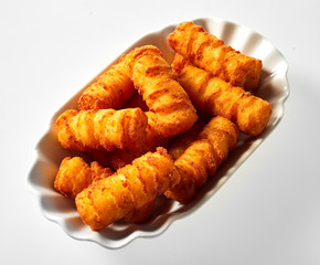Fluted dish with golden fried potato croquettes fingers