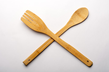 Vintage Wooden Spoon and Fork on White Textured Paper. Kitchen and Cooking Concept.
