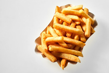 Portion of golden pommes frites isolated on white