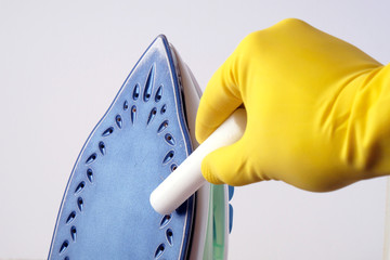 Cleaning  iron from  scale. Hand in glove cleans with  special pencil, close-up.